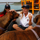 Jennifer Appel, right, and Tasha Fuiava sit with their dogs on the deck of the USS Ashland Monday, Oct. 30, 2017, at White Beach Naval Facility in Okinawa, Japan. (AP Photo/Koji Ueda)